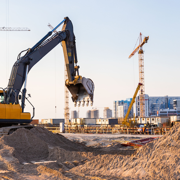 Construction site with an excavator in the middle.