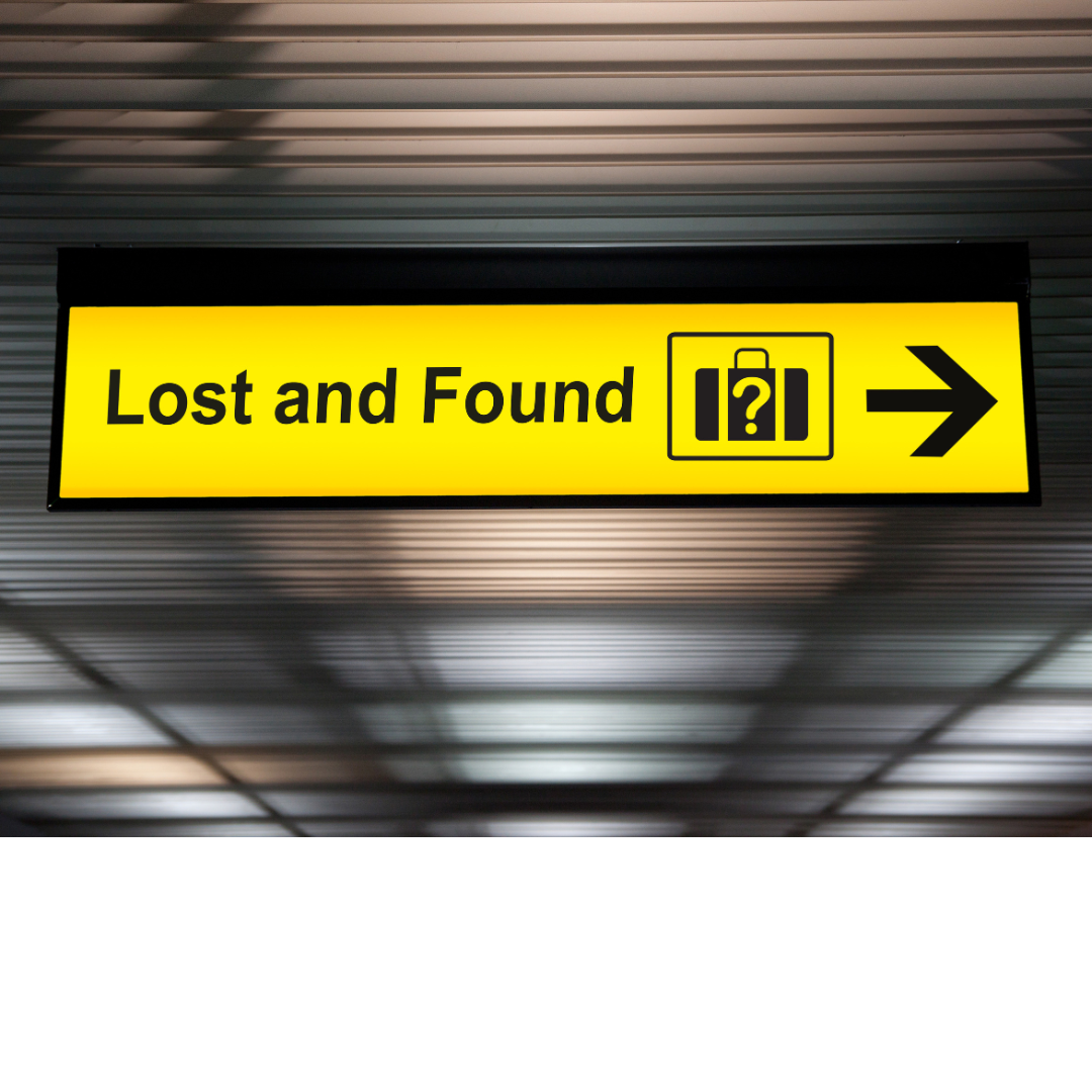 A bright yellow "Lost and Found" sign with an icon of a suitcase and an arrow pointing right.