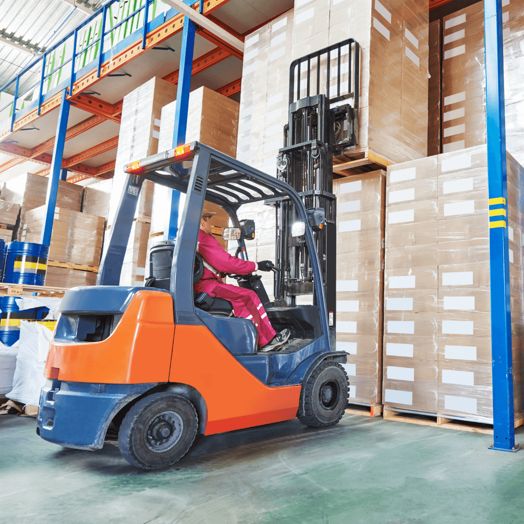 A forklift in a warehouse, lifting boxes stacked on shelves.