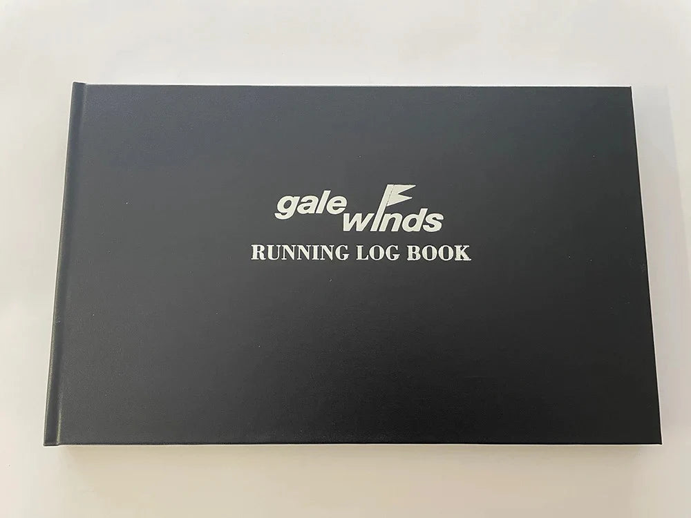 A black log book with white text 'Gale Winds Running Log Book'.